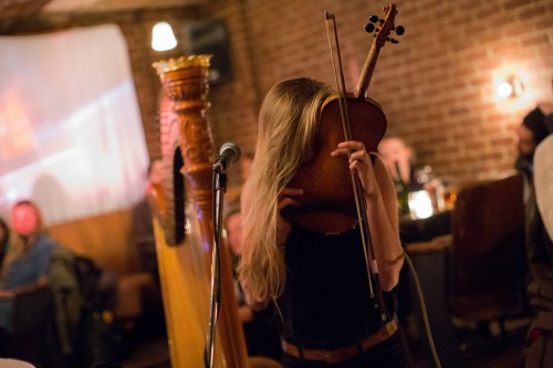 © Photo by David Andrako. Hannah Epperson sings into her violin. "I've spent a lot of the last year in production mode, both working on my own album and composing for other peoples, I became interested in the creation of sounds in general. Which has translated into my live performance in small ways. There are times when playing a violin feels almost claustrophobically restrictive, especially after spending days in the studio with stacks of synths and other instruments. So I've been trying to wrestle different sounds from my instrument, and that was a new one."