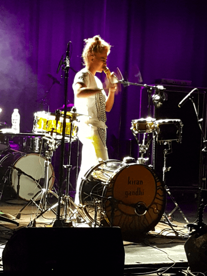 C/O Sonya Patel. 8-inch snare drum, bass drum with a head that has Kiran Gandhi painted on it by an artist friend of hers from Vancouver, and District Drum Company light-up drum attached to a sensory percussion trigger allowing her to play different electronic samples even though she is hitting a real drum.