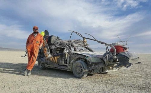 Superchief Gallery LA artist Ryan C. Doyle with his CarCroach at sunrise at Burning Man 2016