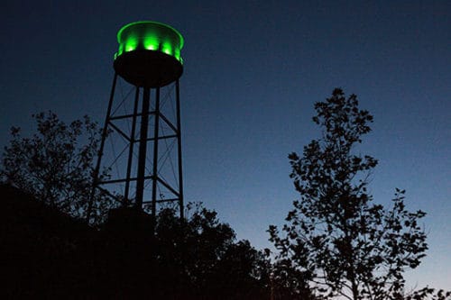 The Water Tower illuminates Franklin and Milton in Green Light