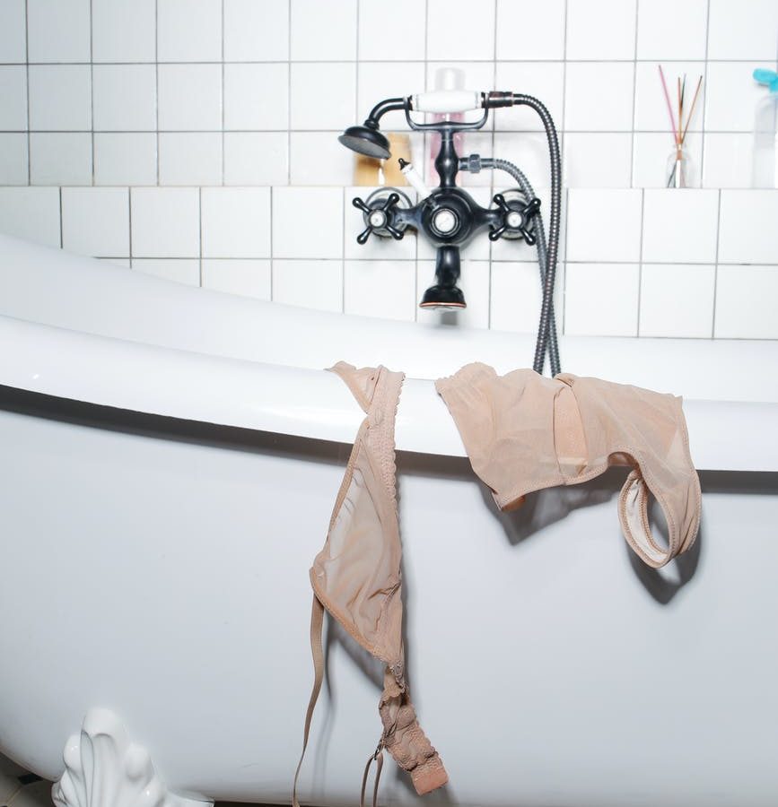 pink towel on stainless steel shower head