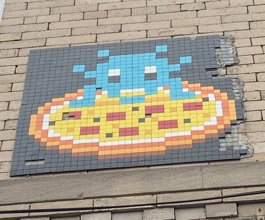 the intact Pizza Invader mosaic mounted above the pizzeria on Nassau Avenue in Greenpoint, Brooklyn